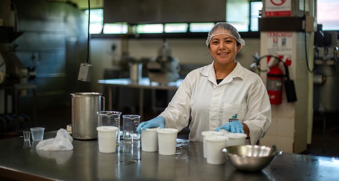 research-700x375 Student smiling in lab